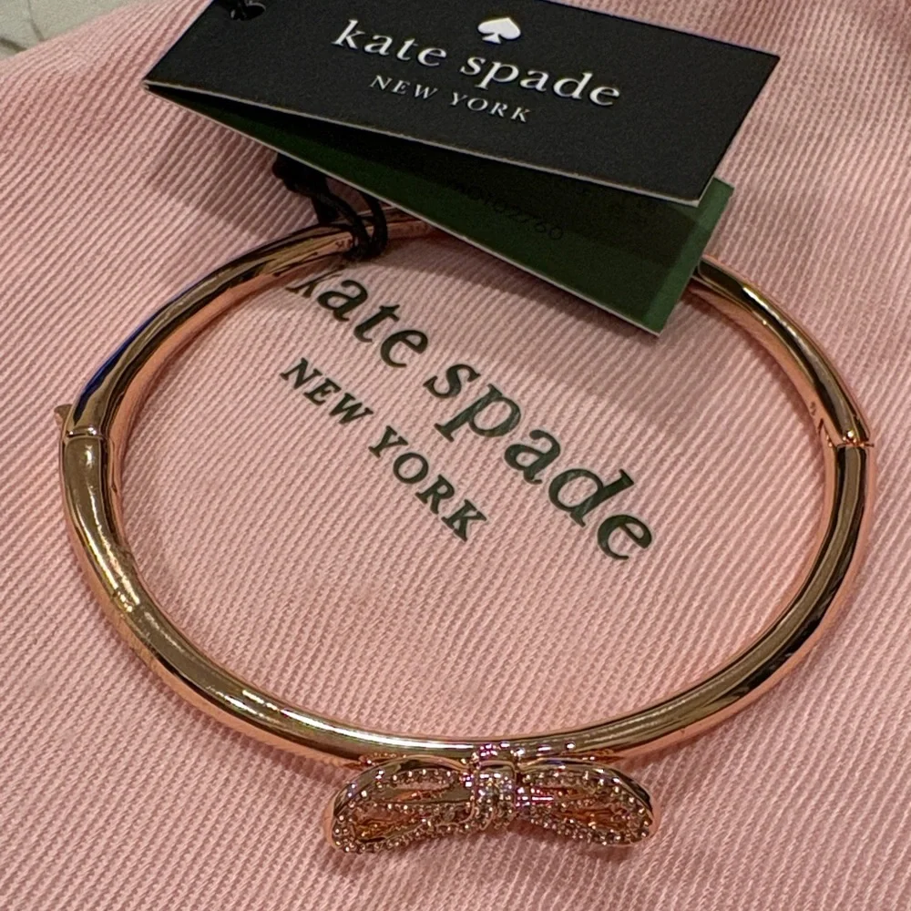 Rose gold Kate Spade bracelet with bow on top. Never used. Tag included. - Picture 1 of 4